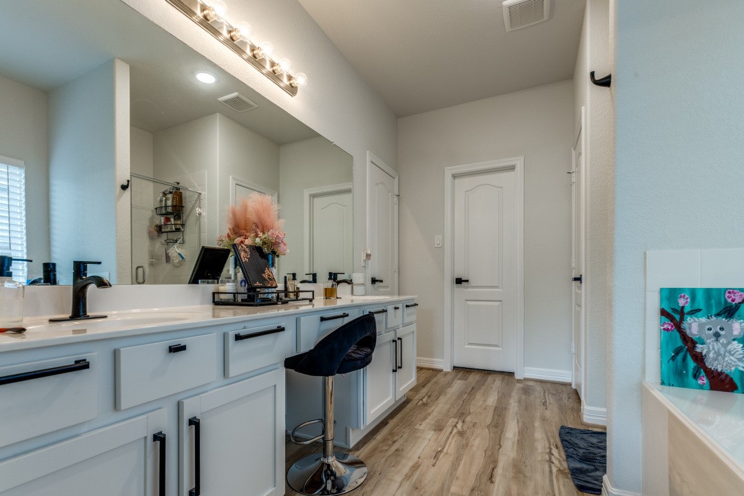 8327 Calico Pennant Way Fulshear, TX 77441 - Photo 23 of 44 a view with a sink and a mirror