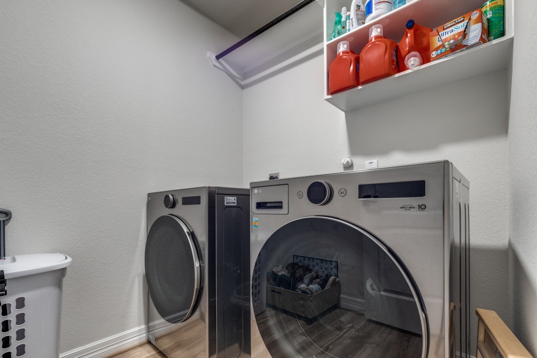 8327 Calico Pennant Way Fulshear, TX 77441 - Photo 25 of 44 a utility room with dryer and washer