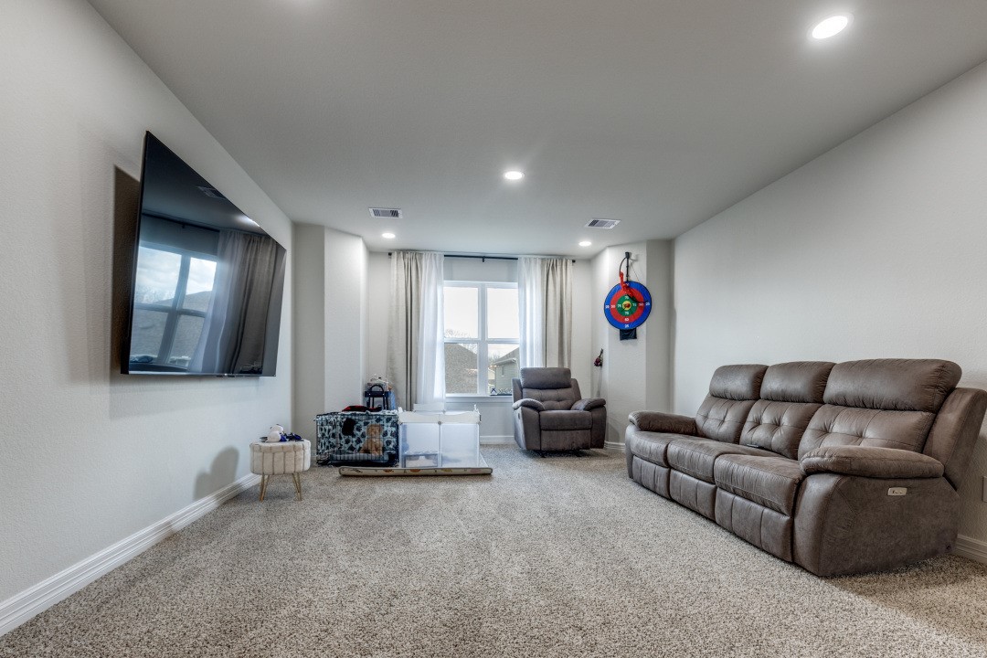 8327 Calico Pennant Way Fulshear, TX 77441 - Photo 26 of 44 a living room with furniture and a flat screen tv