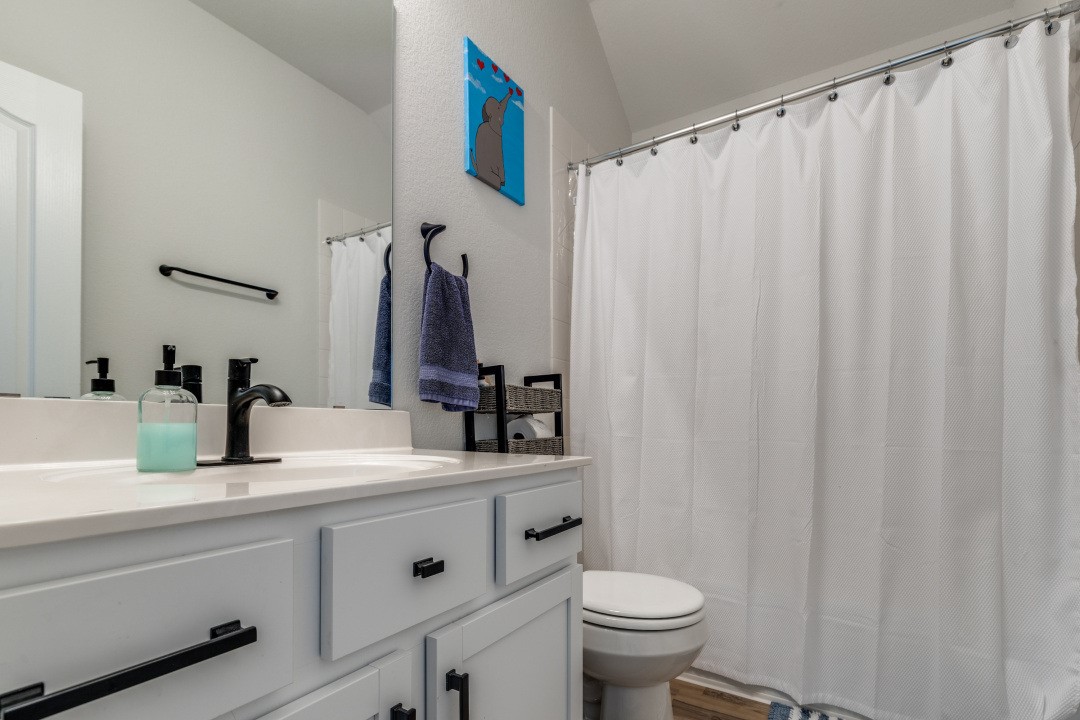 8327 Calico Pennant Way Fulshear, TX 77441 - Photo 28 of 44 a bathroom with a sink and a mirror