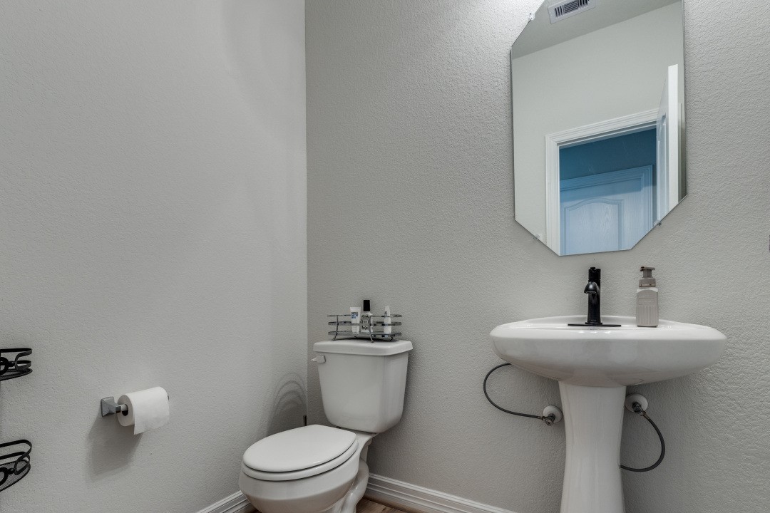 8327 Calico Pennant Way Fulshear, TX 77441 - Photo 29 of 44 a bathroom with a sink toilet and a mirror