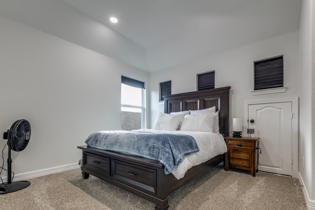 8327 Calico Pennant Way Fulshear, TX 77441 - Photo 30 of 44 a bedroom with a bed and a tv