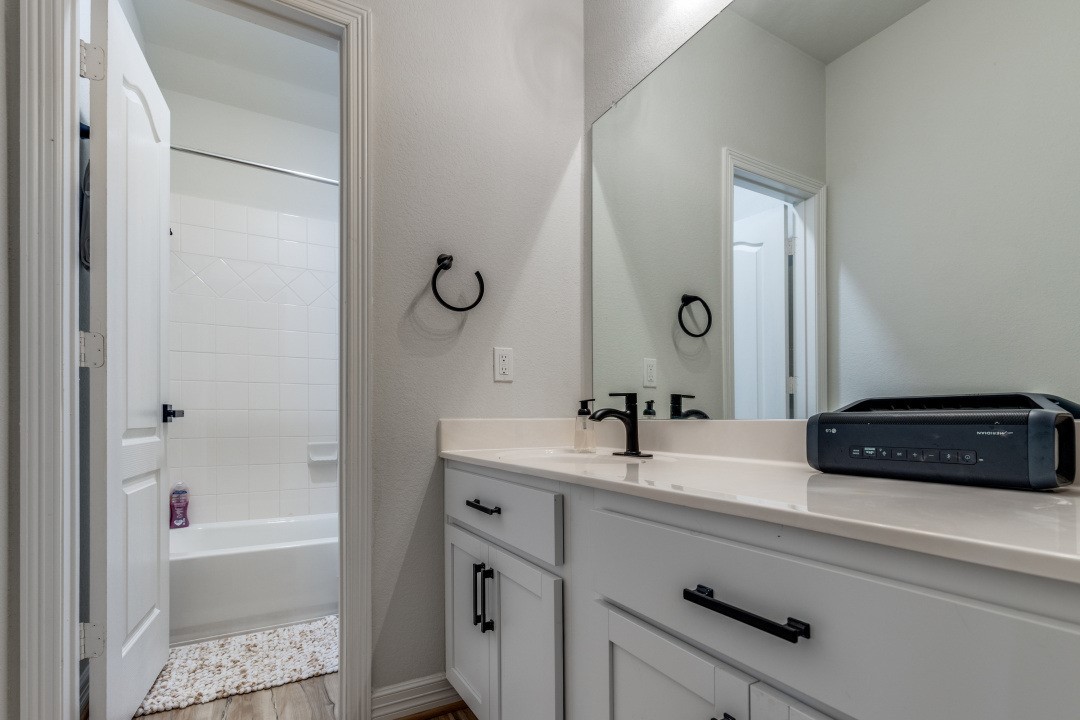 8327 Calico Pennant Way Fulshear, TX 77441 - Photo 33 of 44 a bathroom with a tub sink and mirror