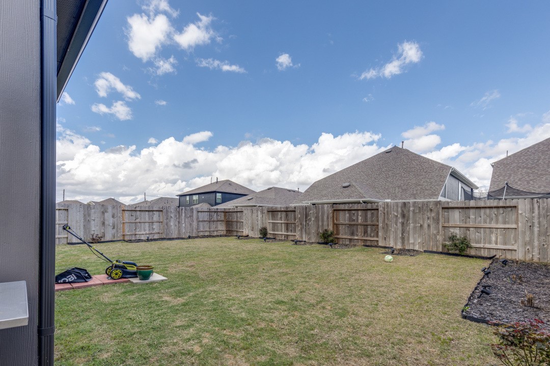 8327 Calico Pennant Way Fulshear, TX 77441 - Photo 39 of 44 a view of a house with a big yard and large tree