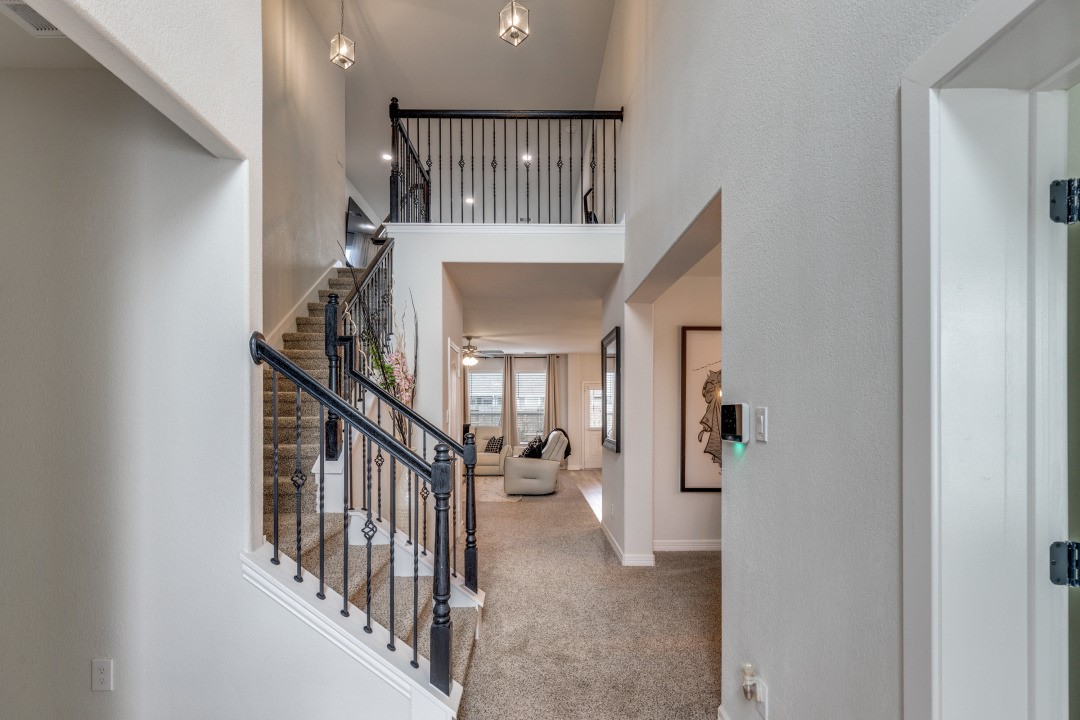 8327 Calico Pennant Way Fulshear, TX 77441 - Photo 5 of 44 a view of staircase with railing and white walls
