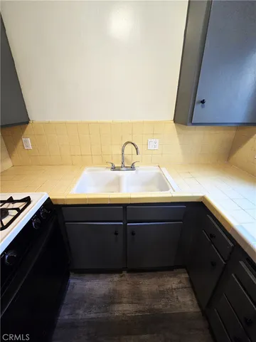 a kitchen with a sink and cabinets