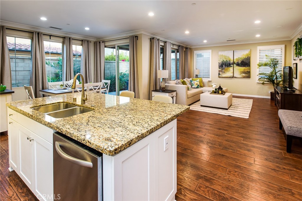 75 Gardenstone Path Irvine, CA 92620 - Photo 11 of 65 a view of kitchen island a sink and living room