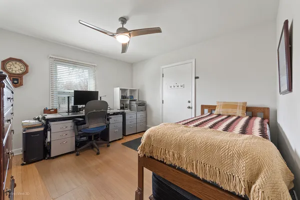 a bedroom with a bed and a desk