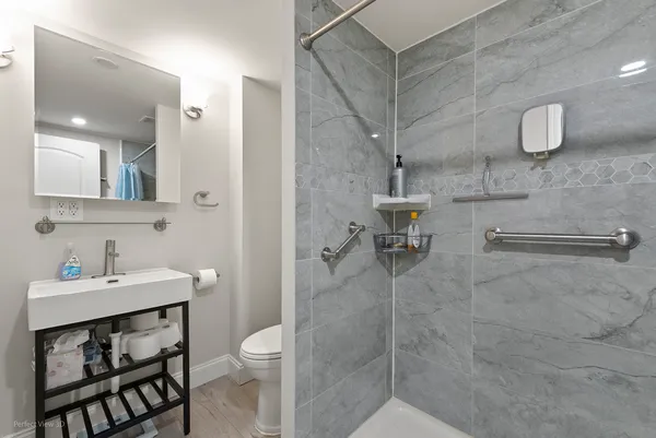 a bathroom with a sink toilet and shower