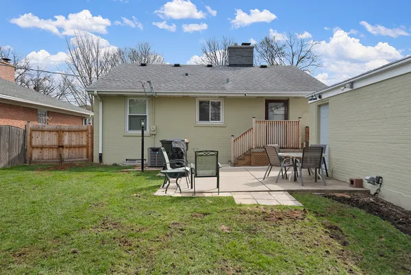 a view of a house with backyard and a patio