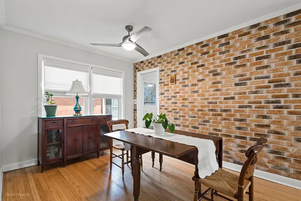 a view of a dining room with furniture and wooden floor