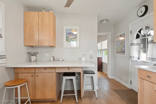 a view of kitchen with wooden floor and seating space