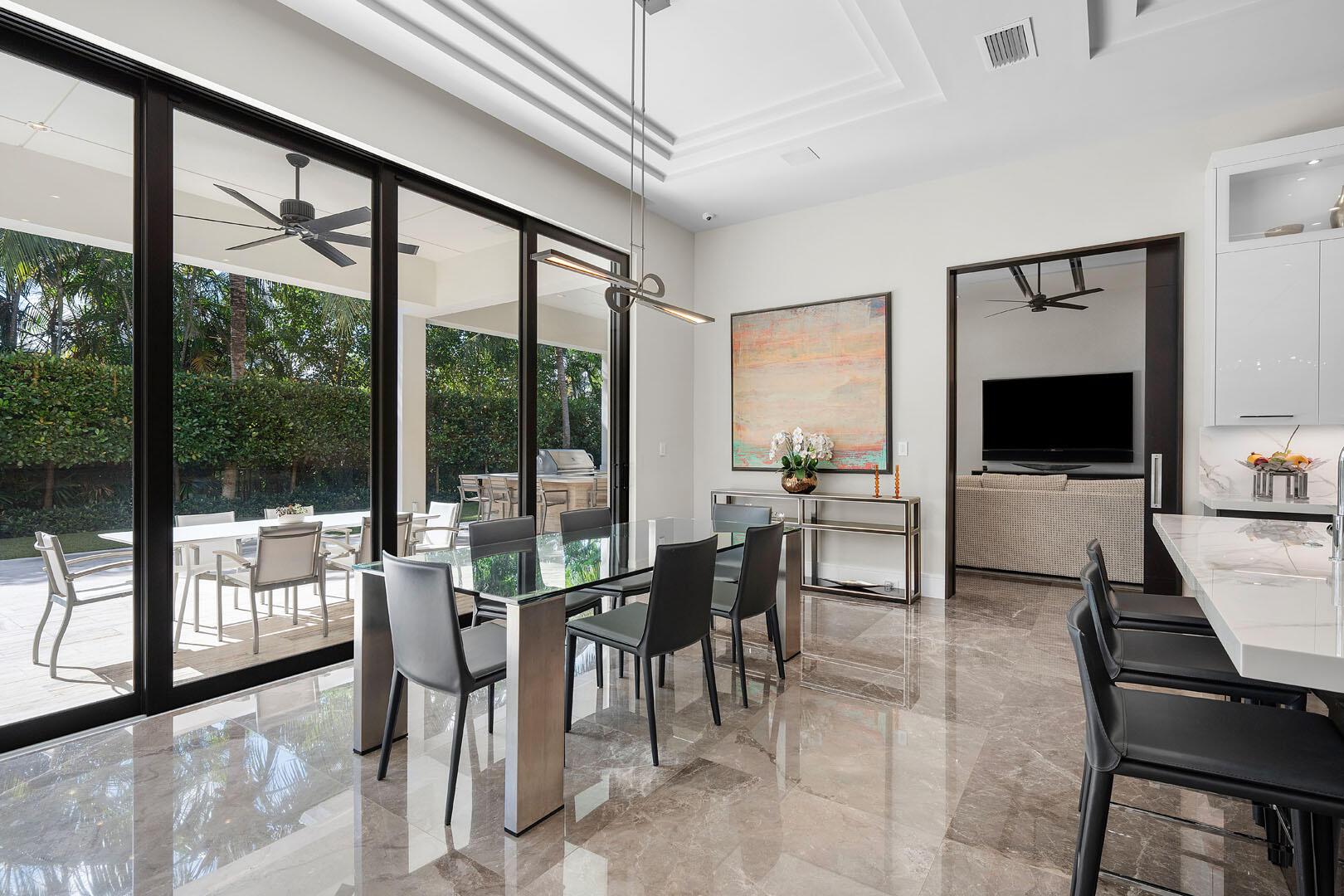 252 South Silver Palm Road Boca Raton, FL 33432 - Photo 24 of 90 a living room with furniture a flat screen tv and a floor to ceiling window