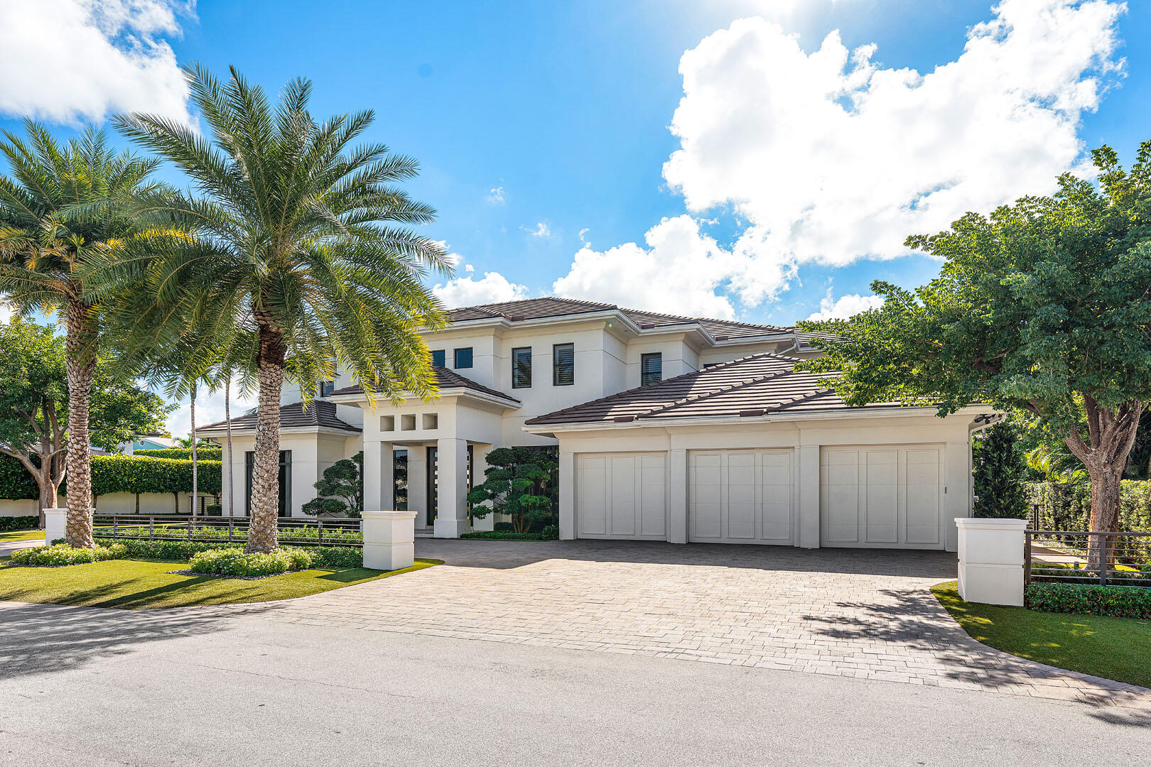 252 South Silver Palm Road Boca Raton, FL 33432 - Photo 5 of 90 a view of a white house with a large tree and a yard in front of it