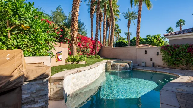 a view of a garden with flowers and trees