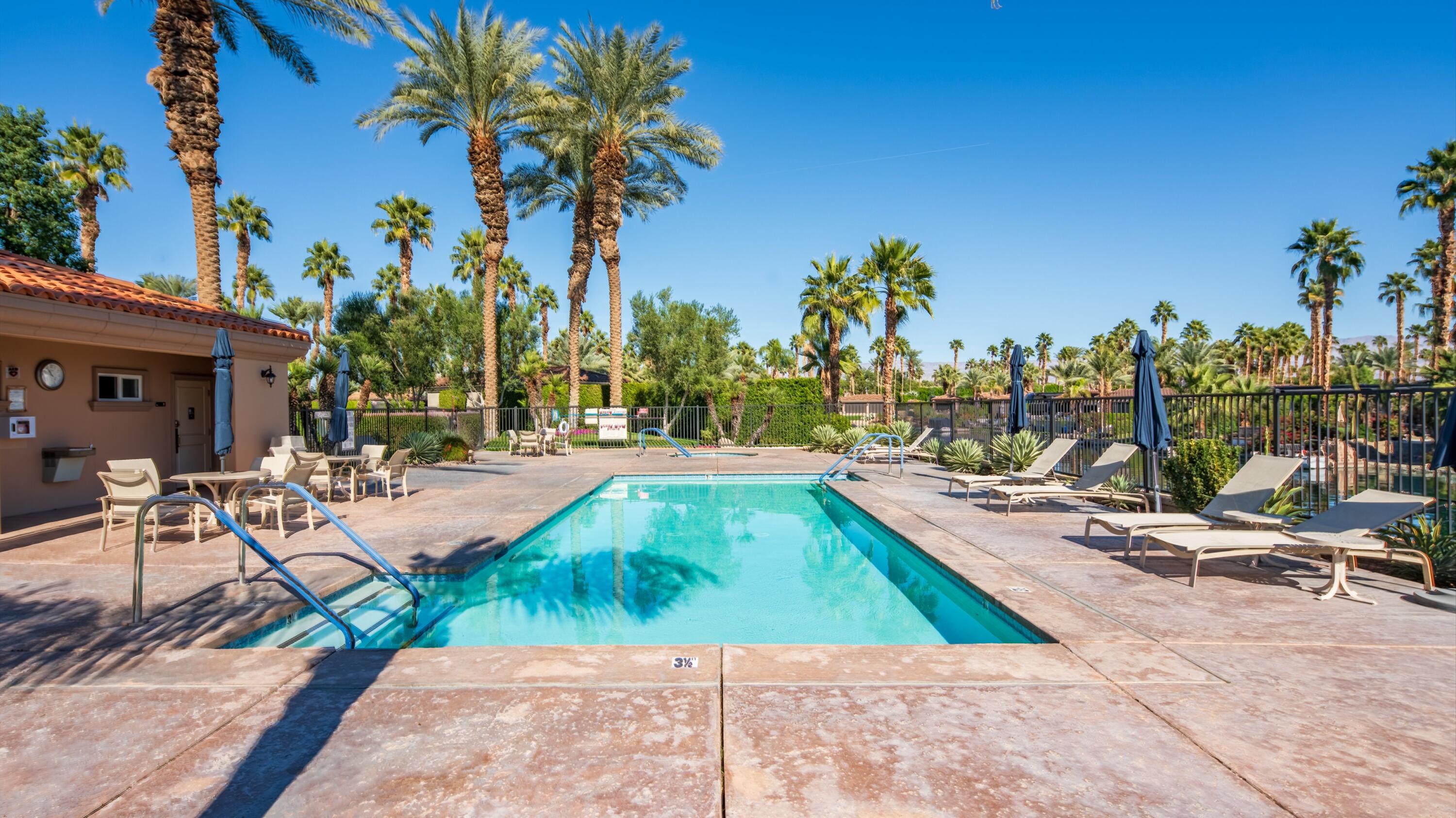 80501 Ave 48, Unit 22 Indio, CA 92201 - Photo 24 of 26 a view of a swimming pool with lounge chairs