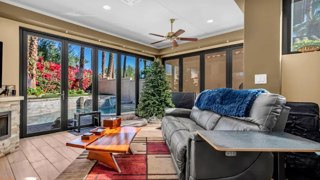 a living room with stainless steel appliances granite countertop furniture a couch and a chandelier