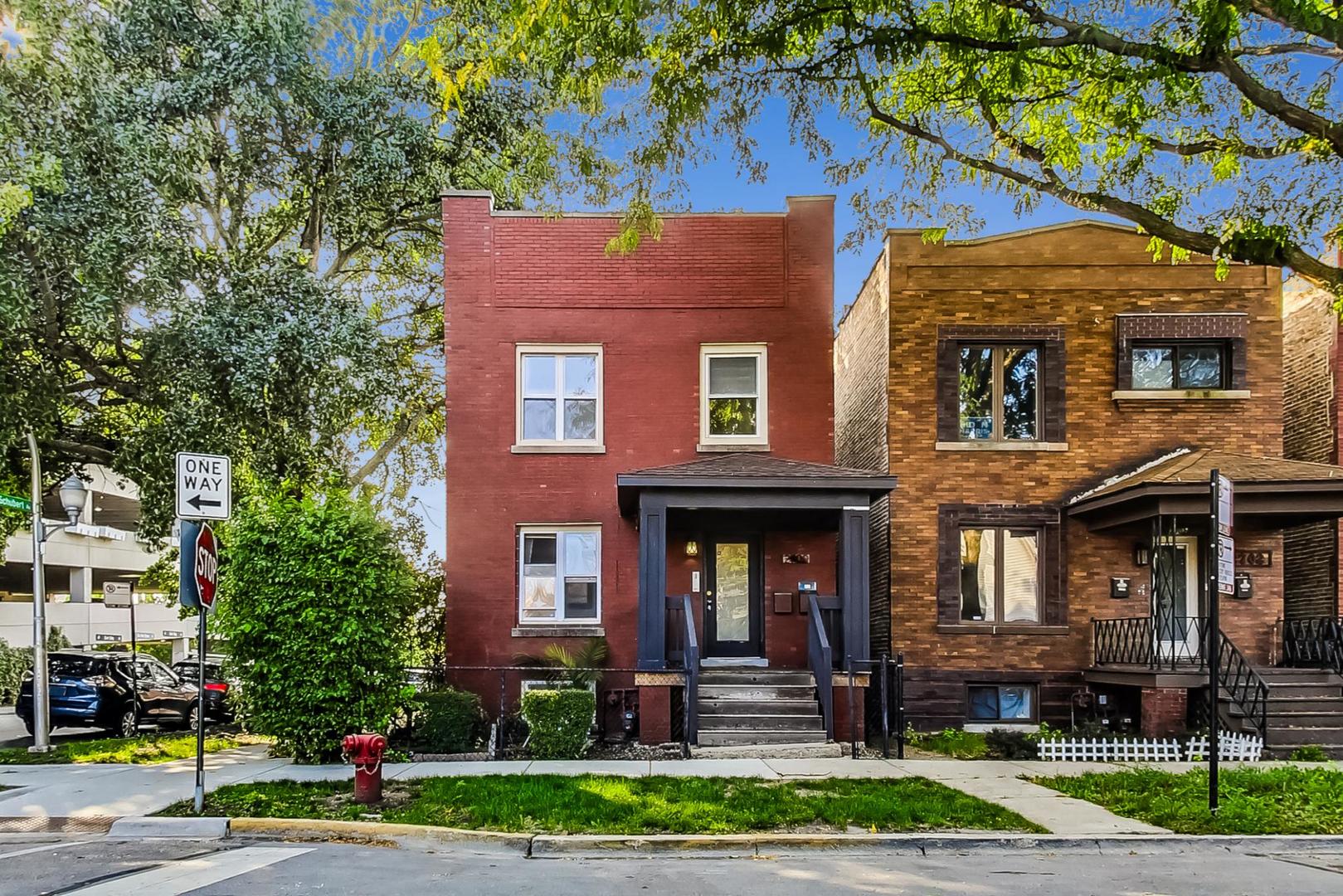 2700 North Artesian Avenue, Unit 1 Chicago, IL 60647 - Photo 1 of 11 a front view of a house with a yard and plants