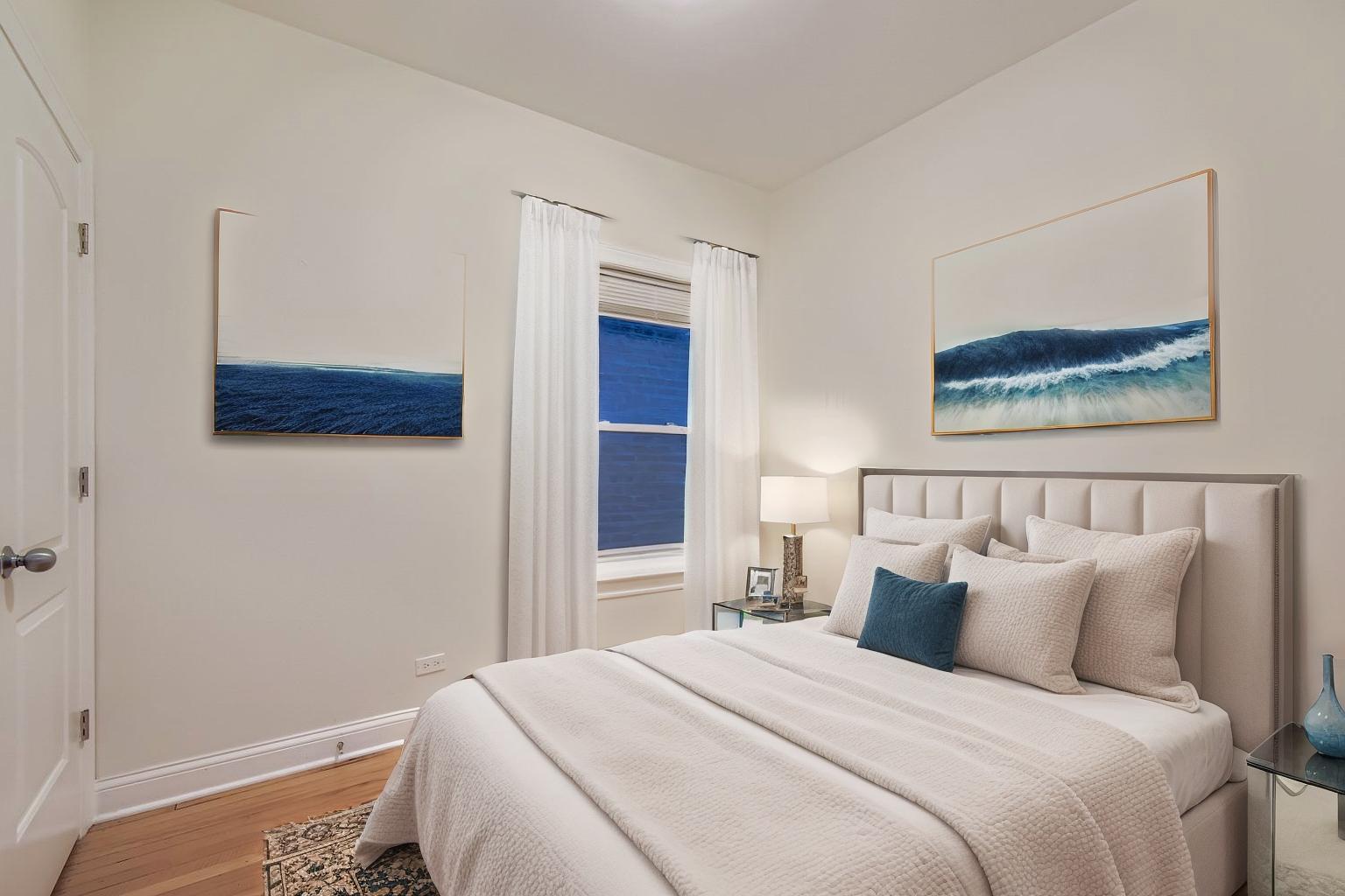 2700 North Artesian Avenue, Unit 1 Chicago, IL 60647 - Photo 5 of 11 a bedroom with a bed and a painting on the wall