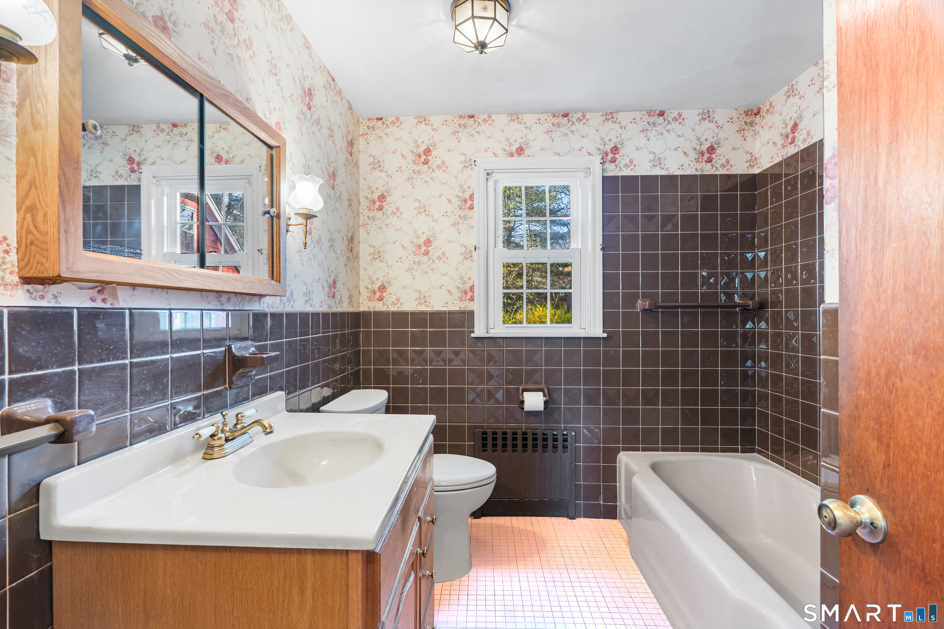 27 Valley Road Shelton, CT 06484 - Photo 12 of 32 a bathroom with a sink mirror bathtub and next to a window