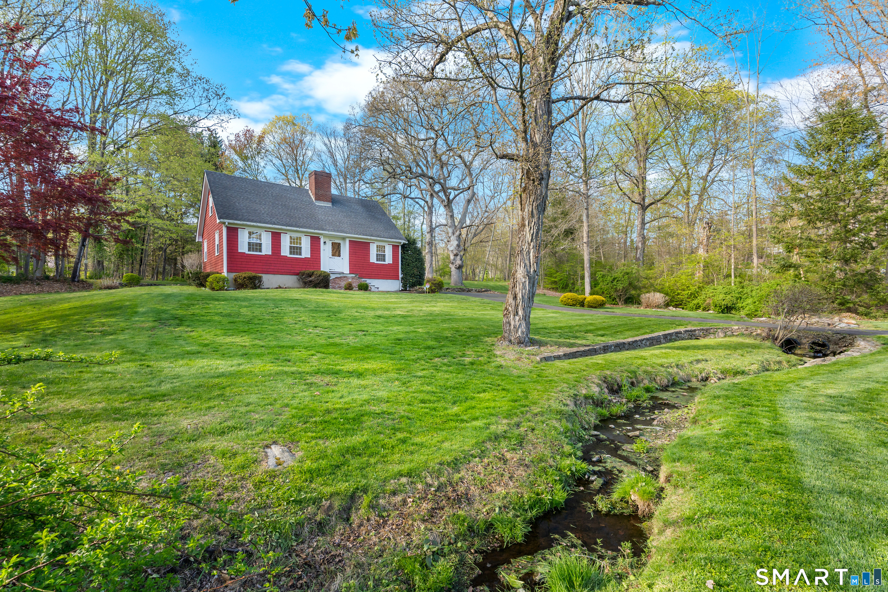 27 Valley Road Shelton, CT 06484 - Photo 3 of 32 a backyard of a house with lots of green space and fountain