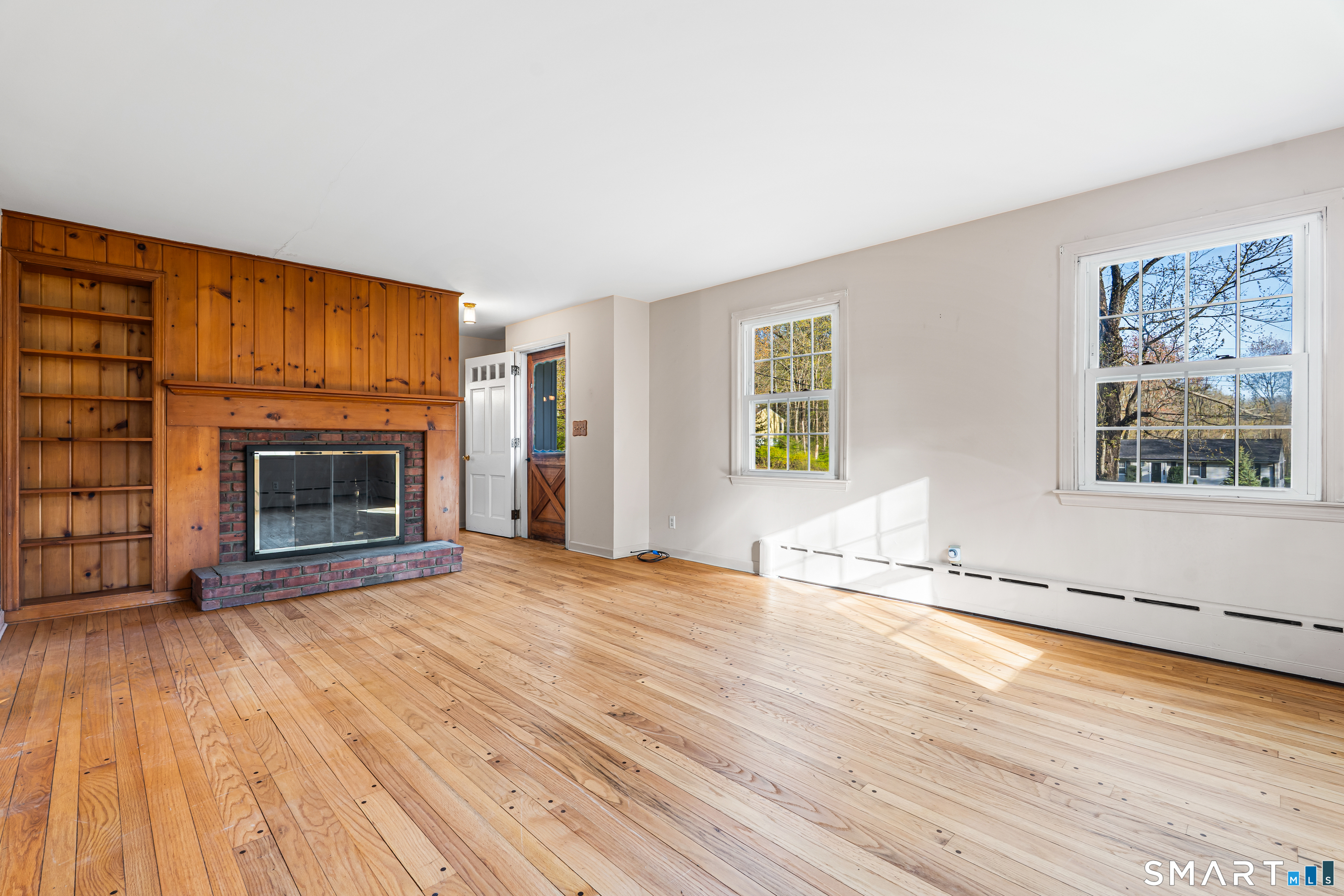 27 Valley Road Shelton, CT 06484 - Photo 5 of 32 wooden floor fireplace and windows in an empty room