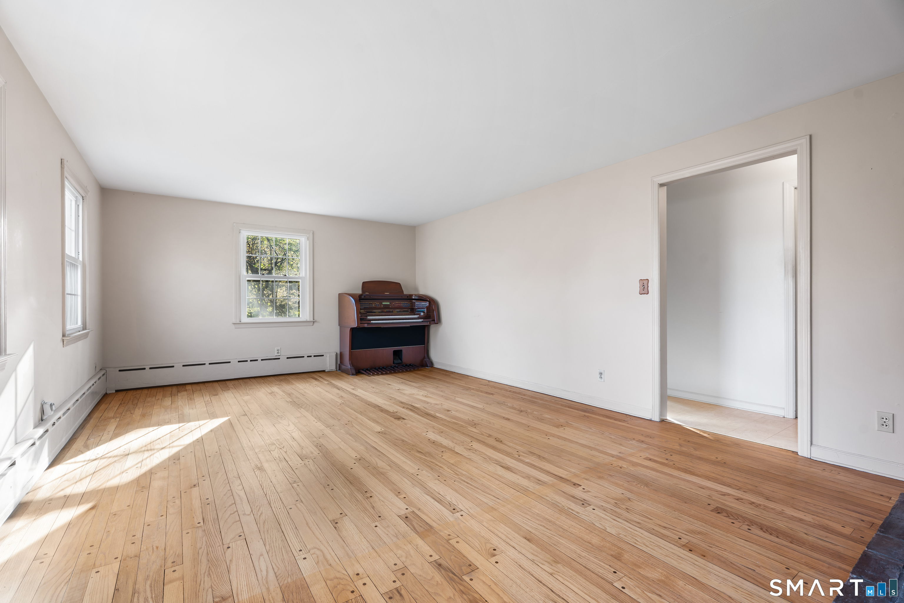 27 Valley Road Shelton, CT 06484 - Photo 6 of 32 a view of empty room with wooden floor and fan