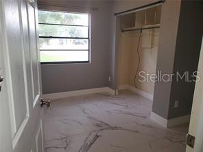 820 Crenshaw Lake Road Lutz, FL 33548 - Photo 11 of 48 a view of an empty room with a window