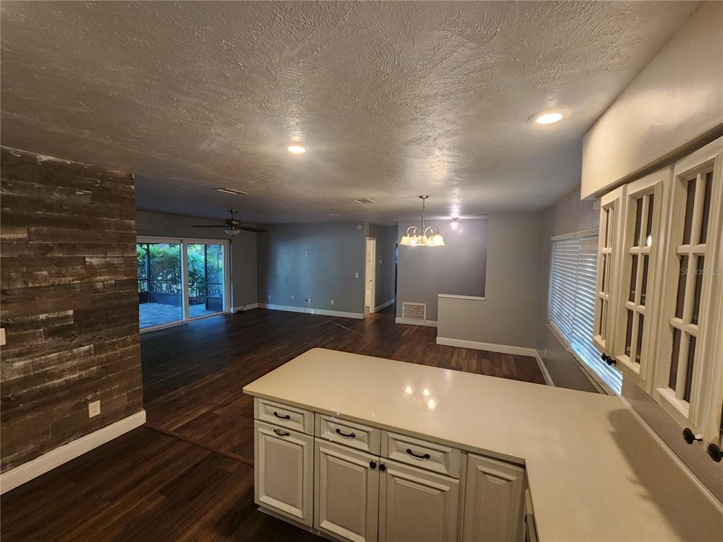 820 Crenshaw Lake Road Lutz, FL 33548 - Photo 19 of 48 a view of a hallway with entryway wooden floor and front door