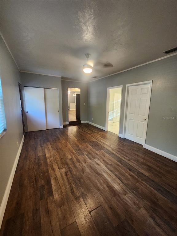 820 Crenshaw Lake Road Lutz, FL 33548 - Photo 21 of 48 a view of an empty room and wooden floor