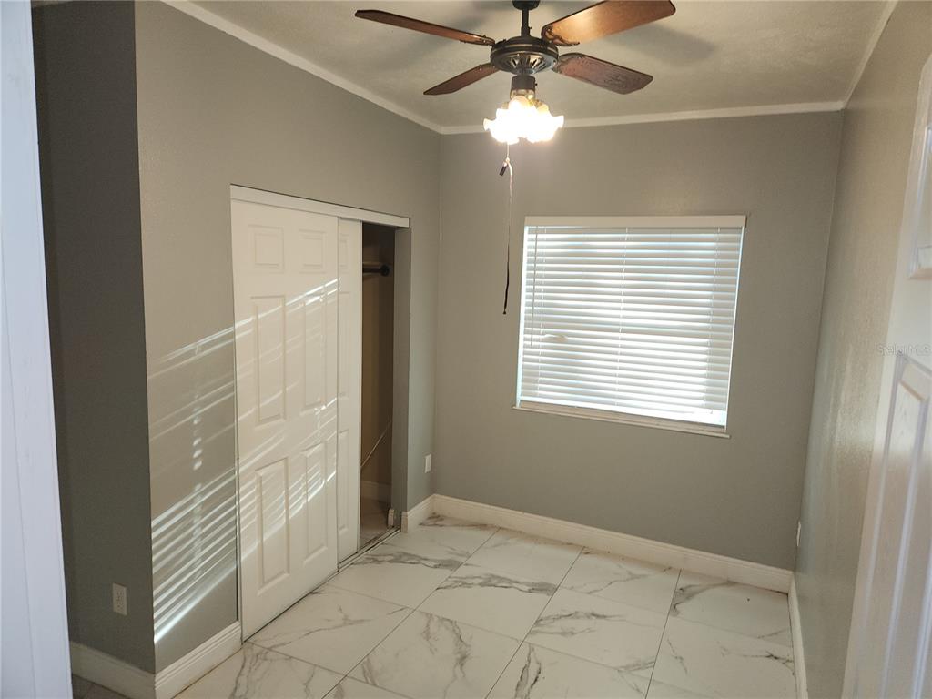820 Crenshaw Lake Road Lutz, FL 33548 - Photo 25 of 48 a view of an empty room with a window