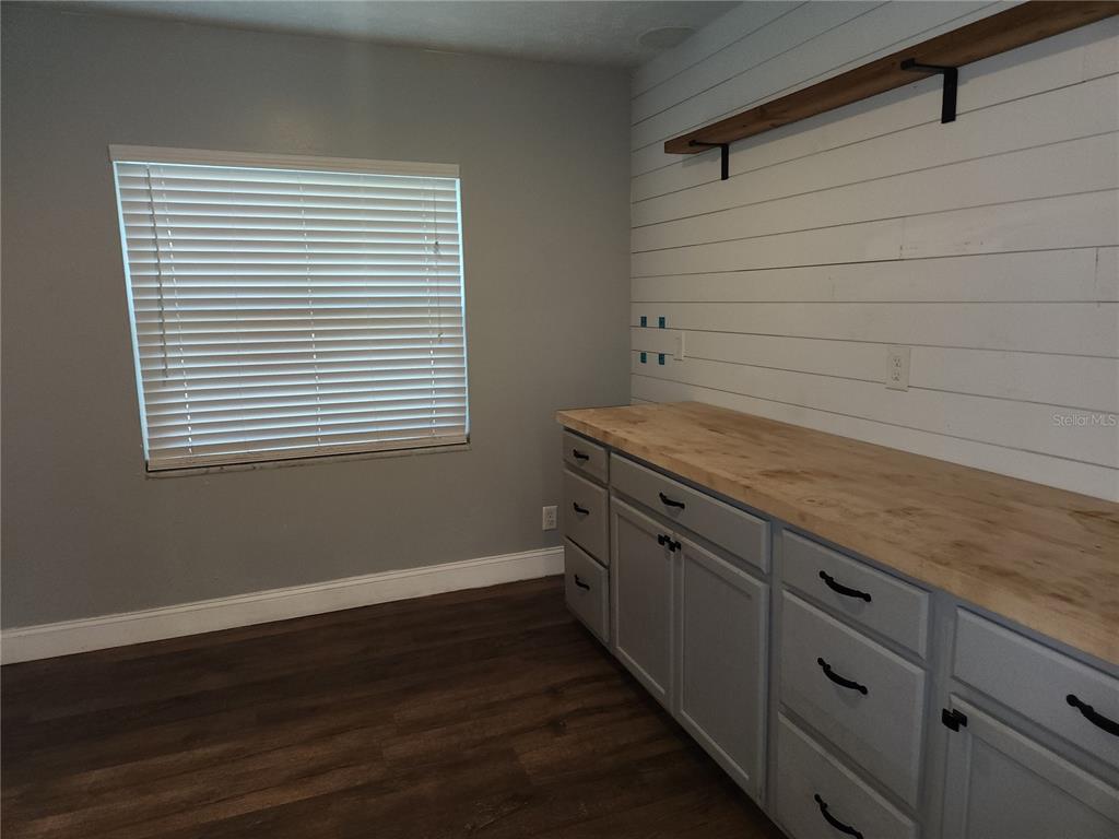 820 Crenshaw Lake Road Lutz, FL 33548 - Photo 26 of 48 a view of a kitchen with wooden floor and a window