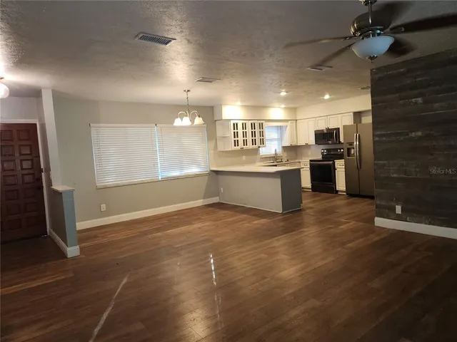 a dining room with furniture and wooden floor