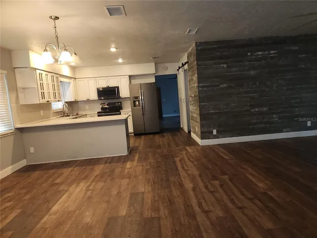 a view of livingroom with hardwood floor and a ceiling fan