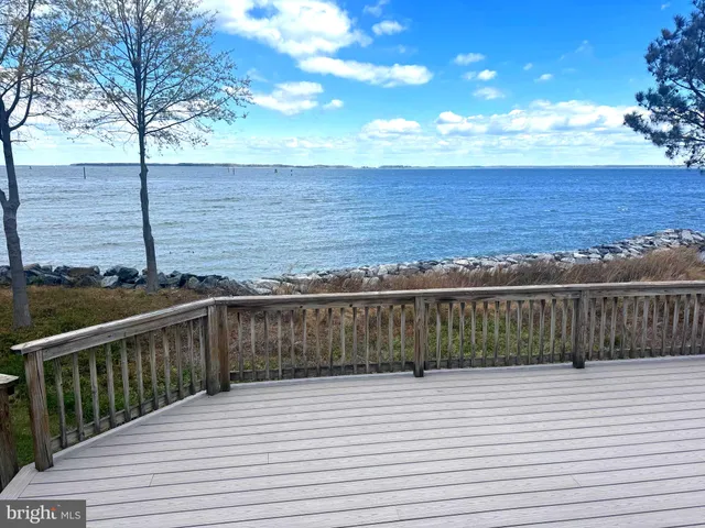 a view of a balcony with wooden floor and fence