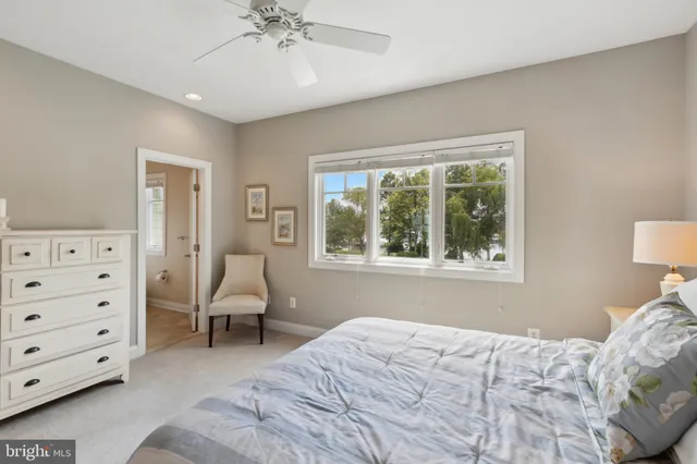 a spacious bathroom with a granite countertop tub a sink and a large window