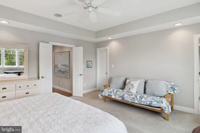 a view of a patio with couches chairs and wooden floor