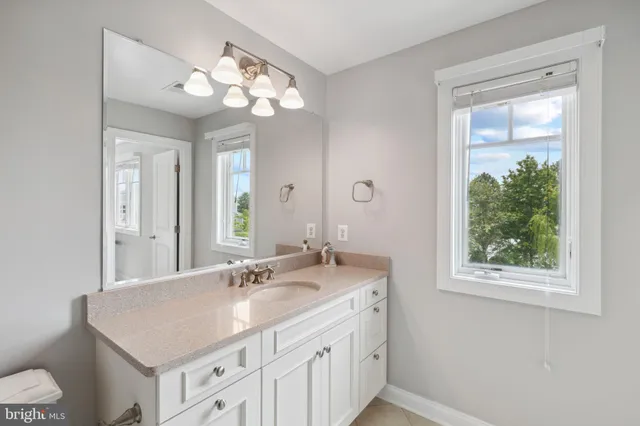 an aerial view of a residential apartment building with a yard and parking spaces