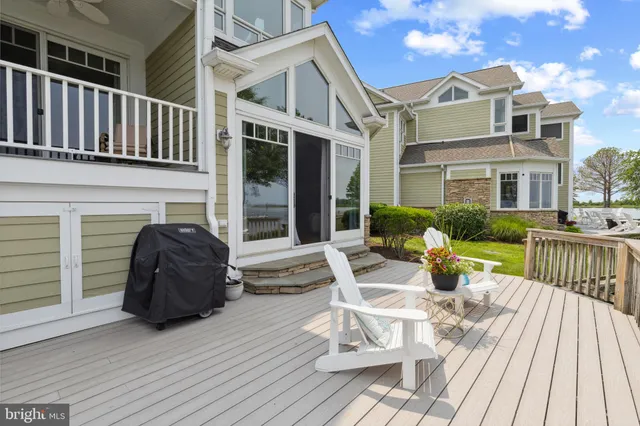 a bedroom with a bed and a large window with the outer view