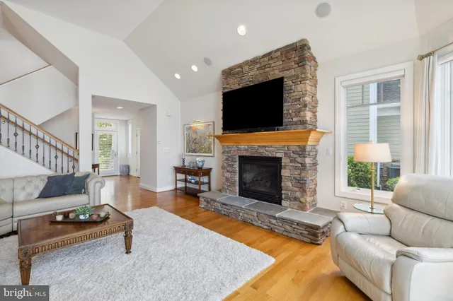 a living room with furniture flat screen tv and a fireplace