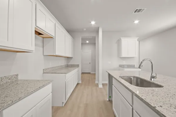 a kitchen with granite countertop sink stainless steel appliances and cabinets