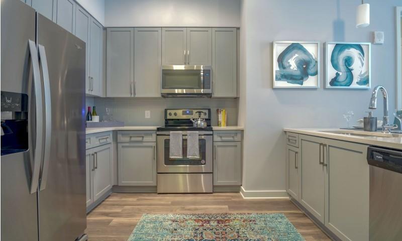 6400 Blue Stone Road, Unit 4018 Sandy Springs, GA 30328 - Photo 14 of 25 a kitchen with stainless steel appliances granite countertop a refrigerator sink and stove