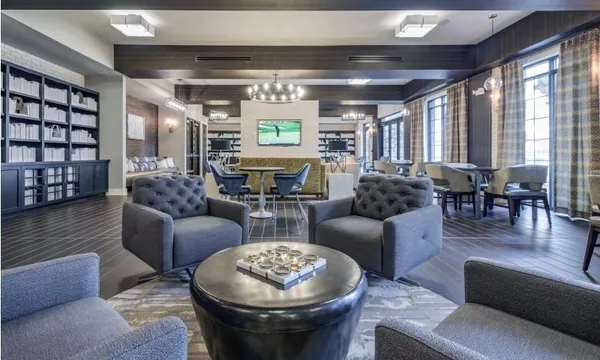 a living room with furniture and a chandelier