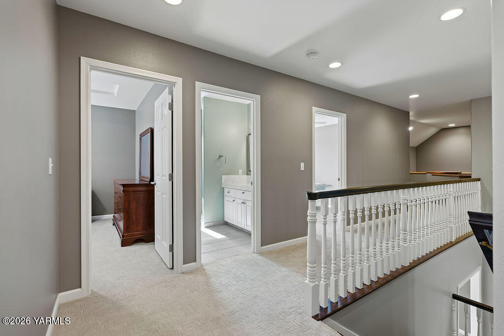 6810 Ravens Gate Way Yakima, WA 98908 - Photo 25 of 49 a view of hallway with wooden floor