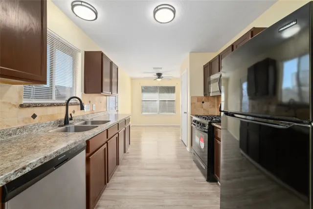 a kitchen with granite countertop a stove and a sink