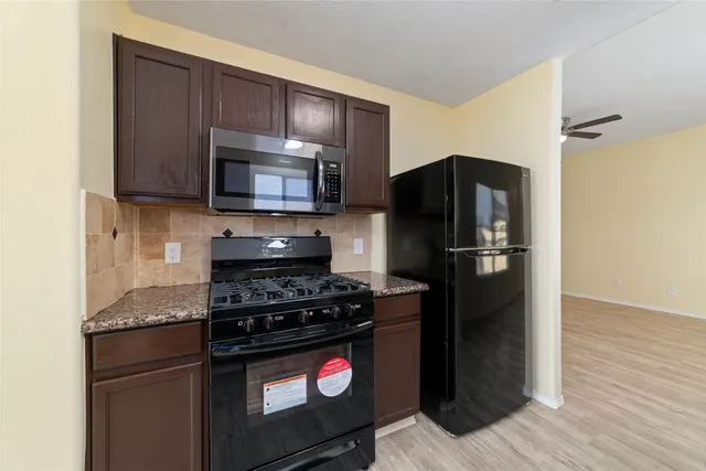 a kitchen with a refrigerator stove and microwave