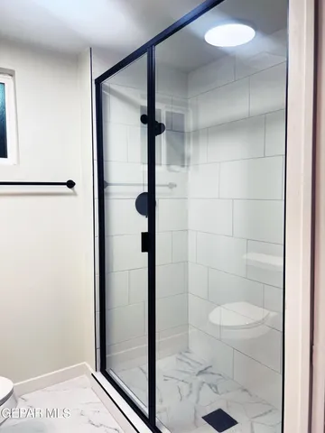 a bathroom with a glass shower door