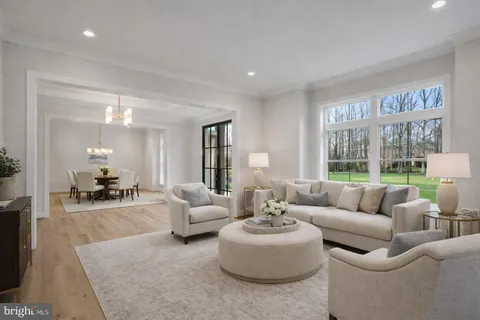 a kitchen with stainless steel appliances a stove a sink a refrigerator a dining table and chairs