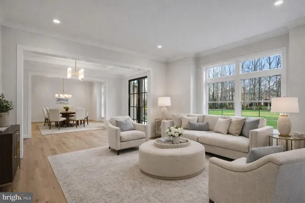 a kitchen with stainless steel appliances a stove a sink a refrigerator a dining table and chairs