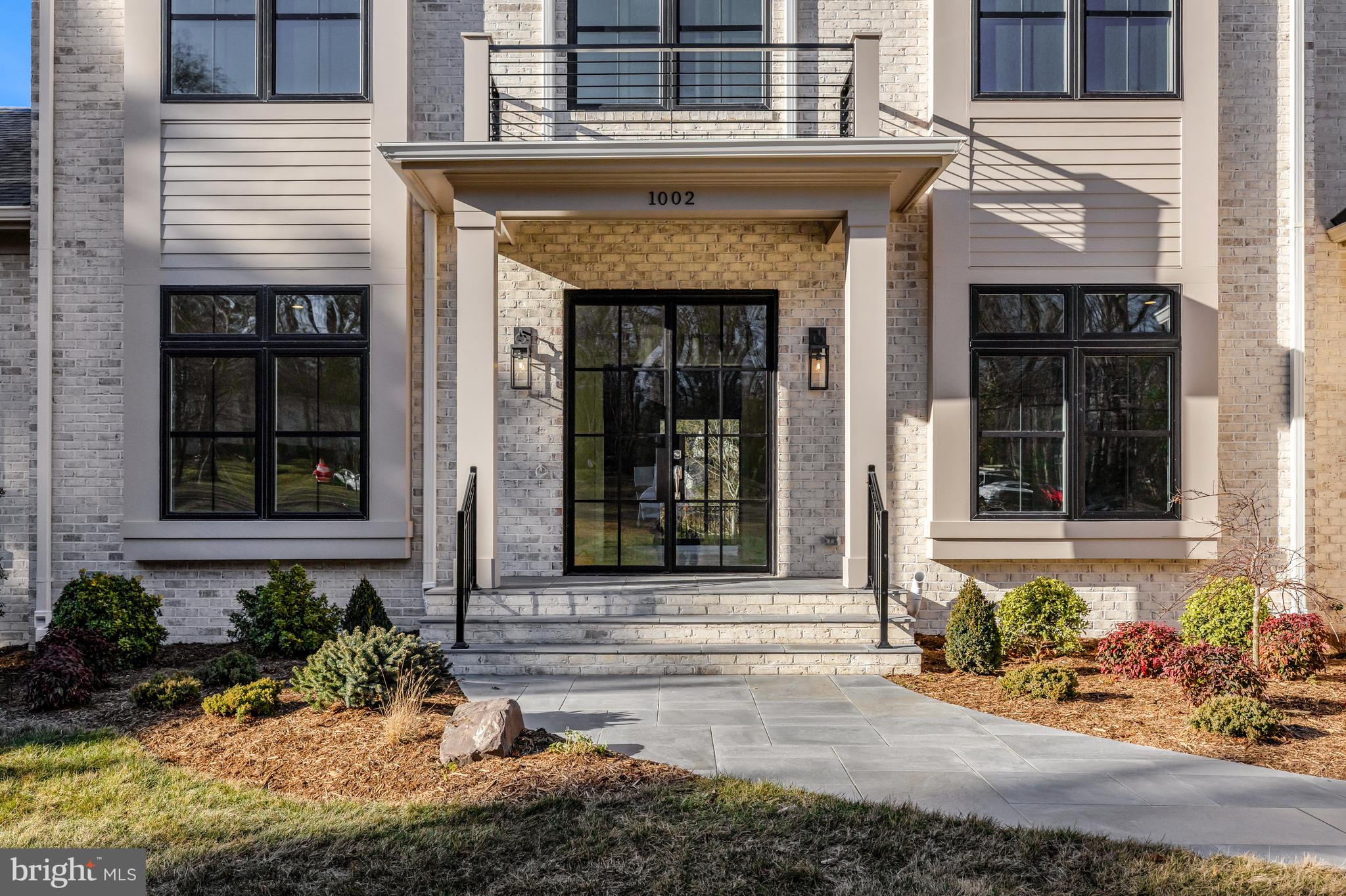1002 Springvale Road Great Falls, VA 22066 - Photo 3 of 73 a front view of a house with a yard